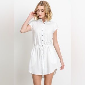 Short sleeve collared shirt dress with elastic waist and button down front.